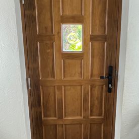 brown door with black handles and letterbox
